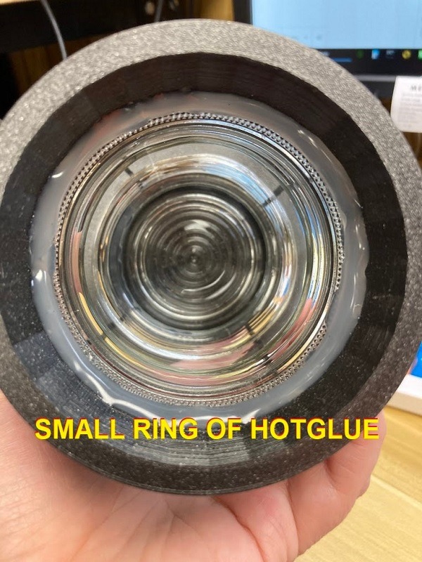 Hot glue ring between glass and plastic